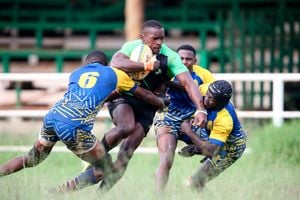 Kabras Sugar's Griffin Chao (centre) charges against Homeboyz Peter Mboya (left) and Godfrey Kile